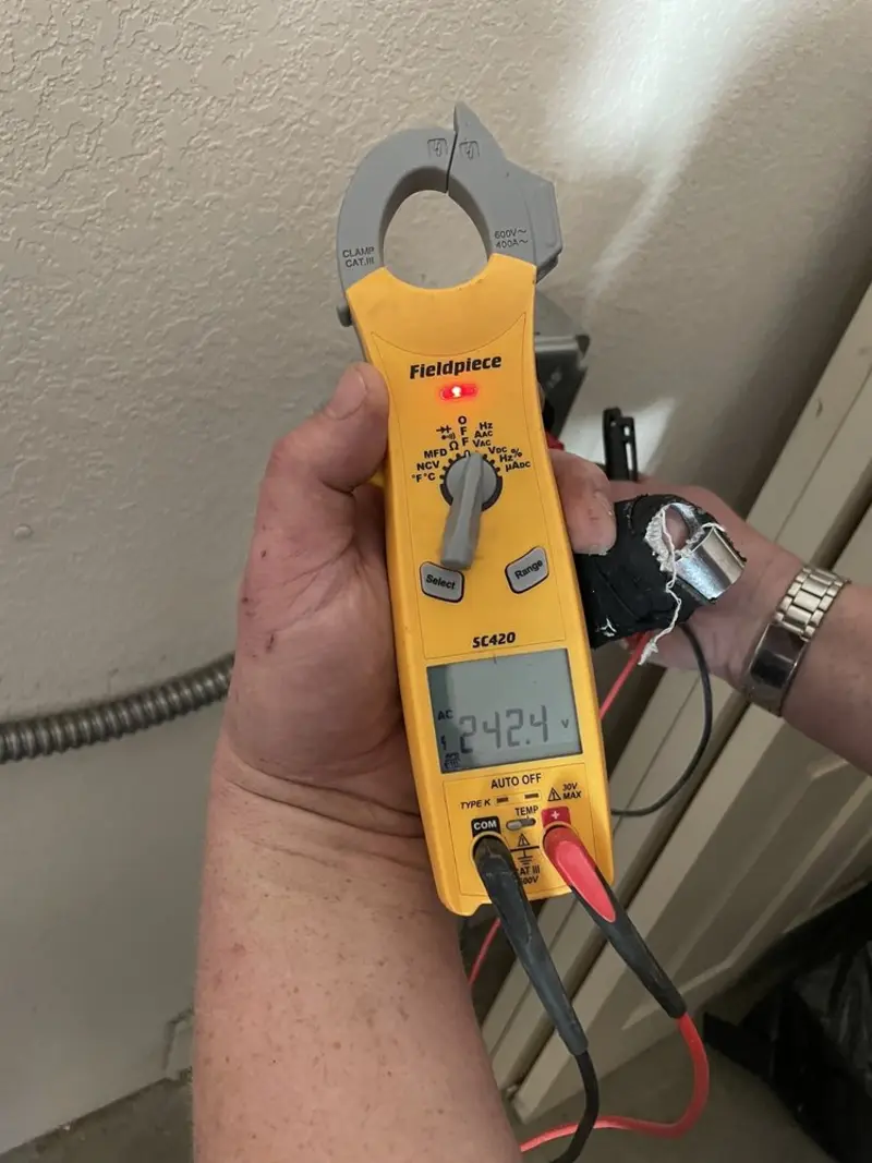 Voltage testing with clamp meter during Ceiling Fan Installation in Oak Hill